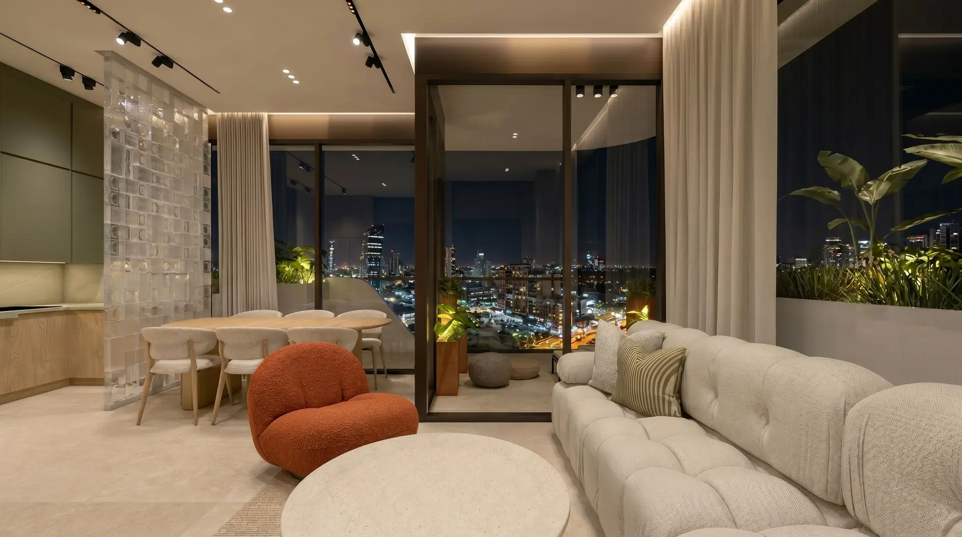 A Selvática residence at night, interior lit warmly